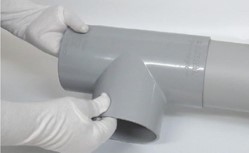 Dry fitting uPVC pressure pipe into fitting socket to check alignment before cementing